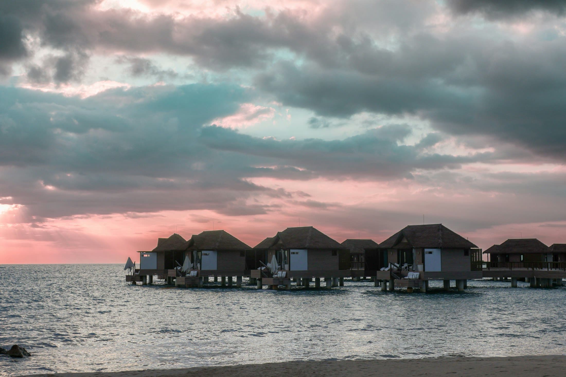 Overwater villas at sunset on the Jamaica south coast