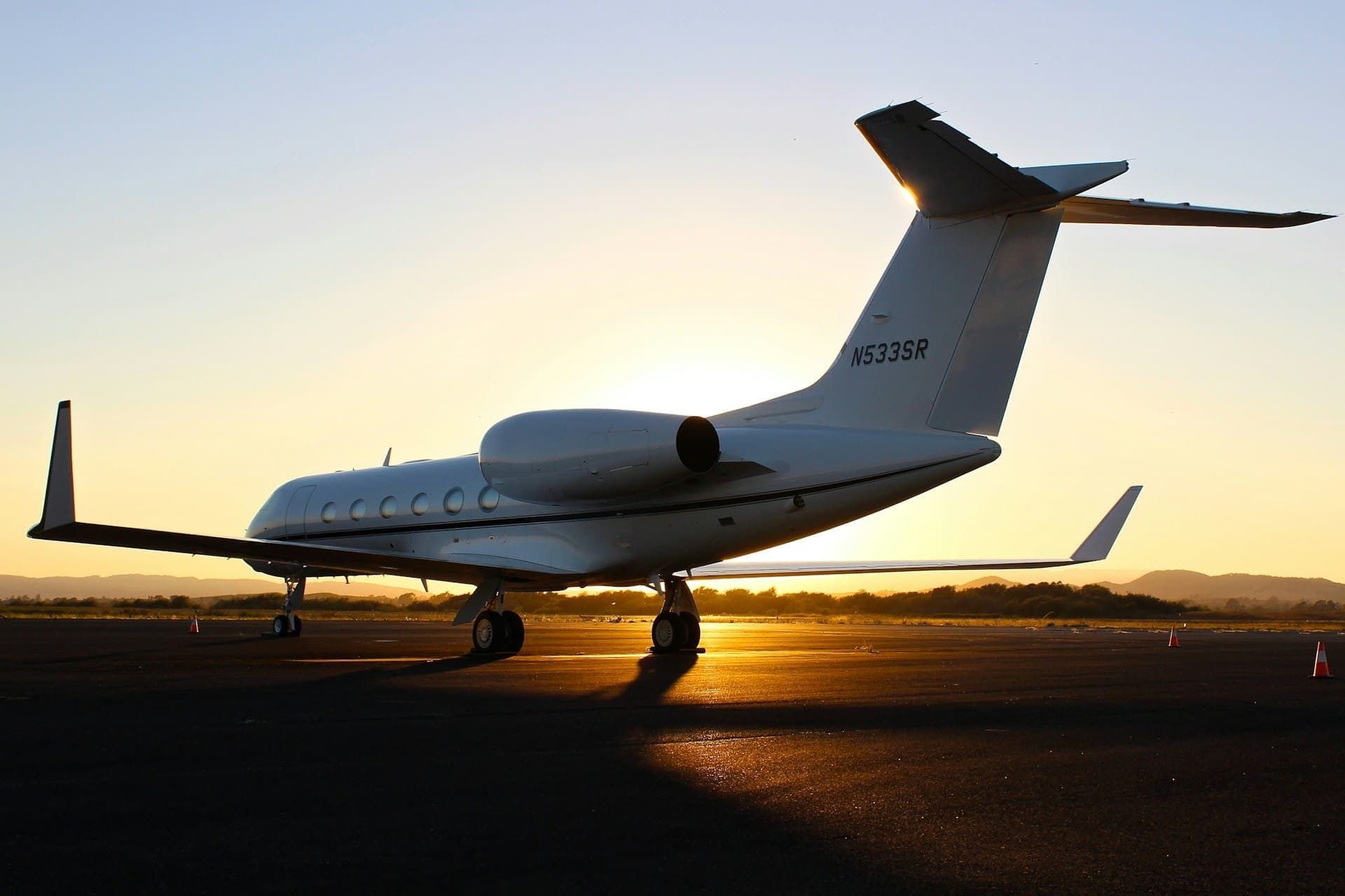 Private jet on the runway at sunset